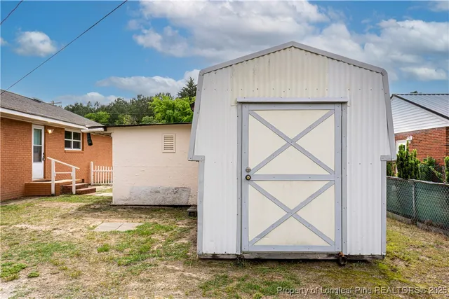 a view of a house with a yard and potted plants