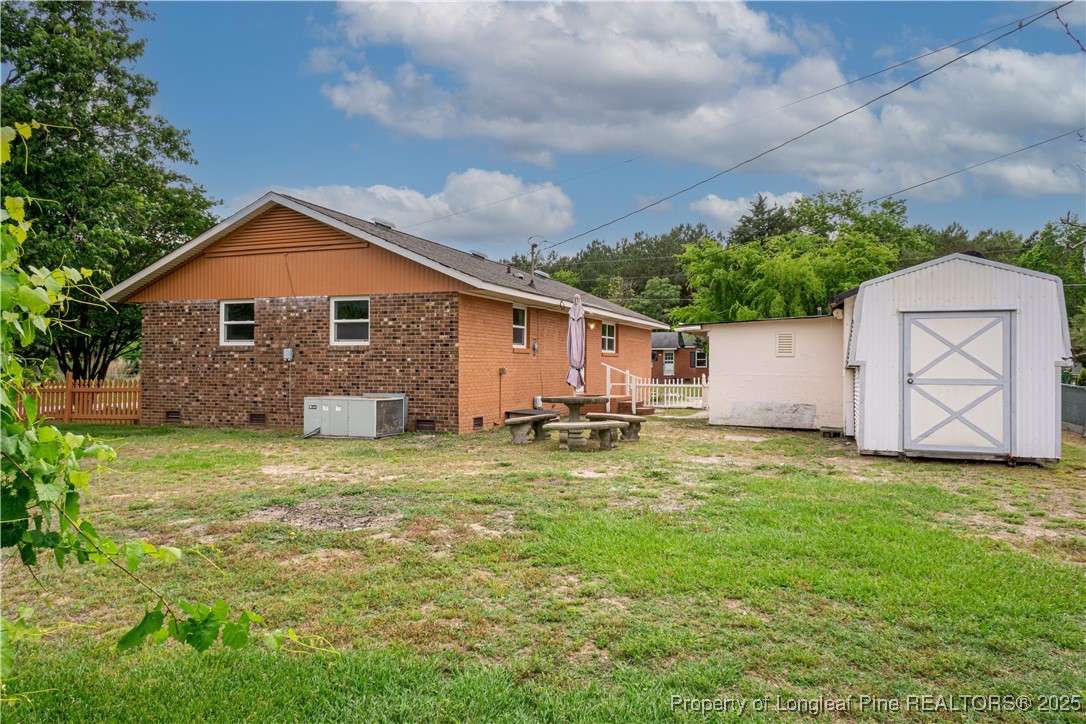 2701 Daly Avenue Spring Lake, NC 28390 - Photo 31 of 34 a front view of house with yard and trees in the background