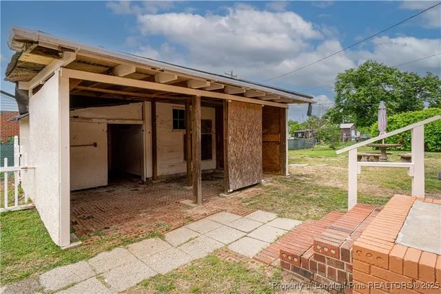 a view of a house with a yard and sitting area