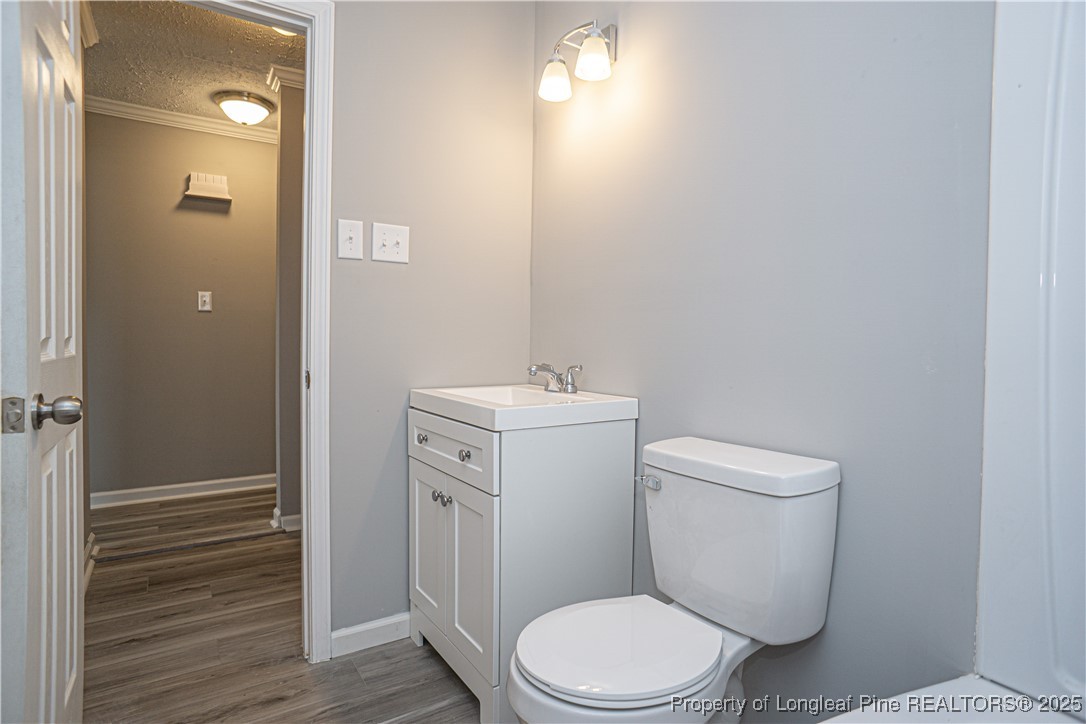 2701 Daly Avenue Spring Lake, NC 28390 - Photo 6 of 34 a white toilet sitting next to a bathroom sink