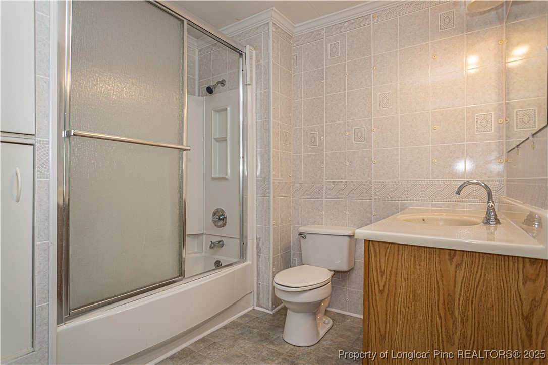 2701 Daly Avenue Spring Lake, NC 28390 - Photo 8 of 34 a bathroom with a sink a toilet and shower