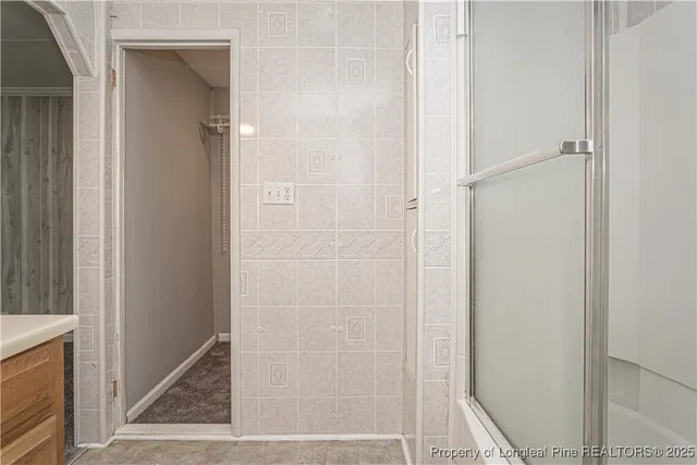 a bathroom with a glass shower door