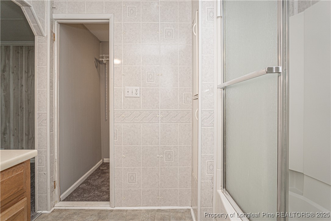 2701 Daly Avenue Spring Lake, NC 28390 - Photo 9 of 34 a bathroom with a glass shower door