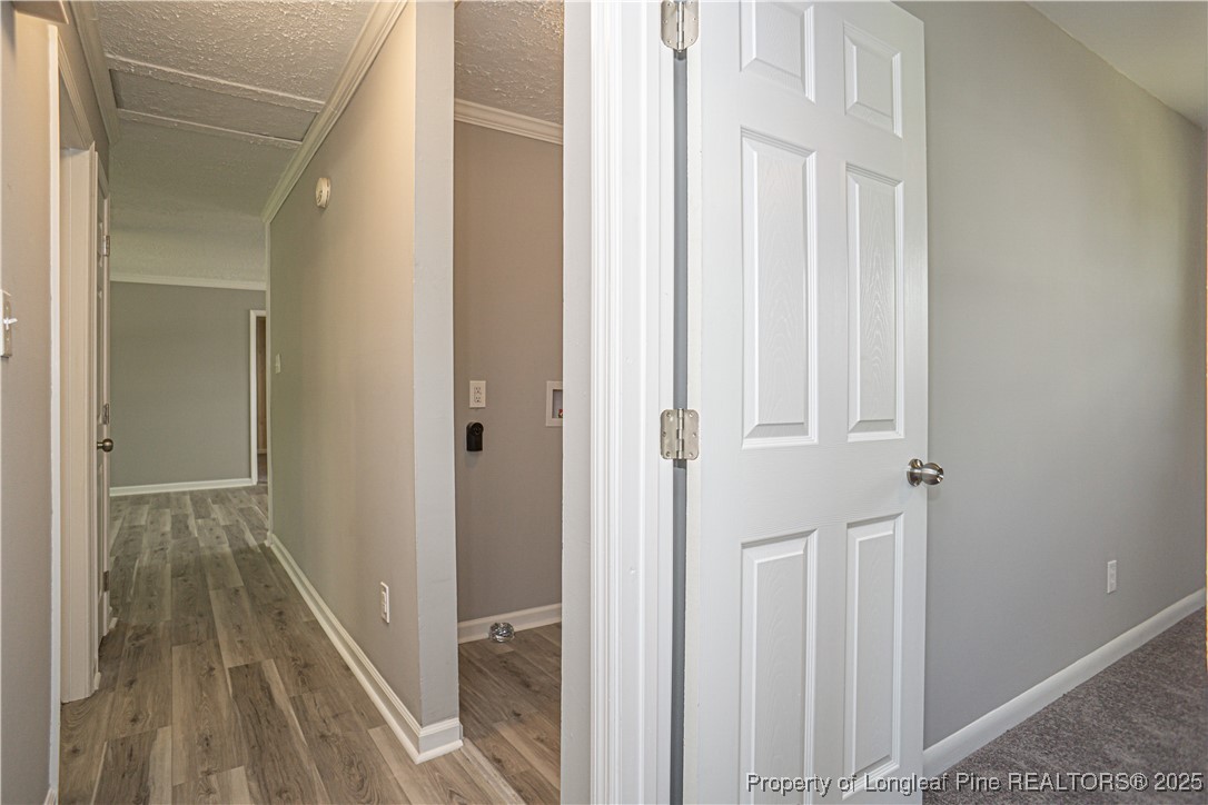 2701 Daly Avenue Spring Lake, NC 28390 - Photo 10 of 34 a view of a hallway with a wooden floor