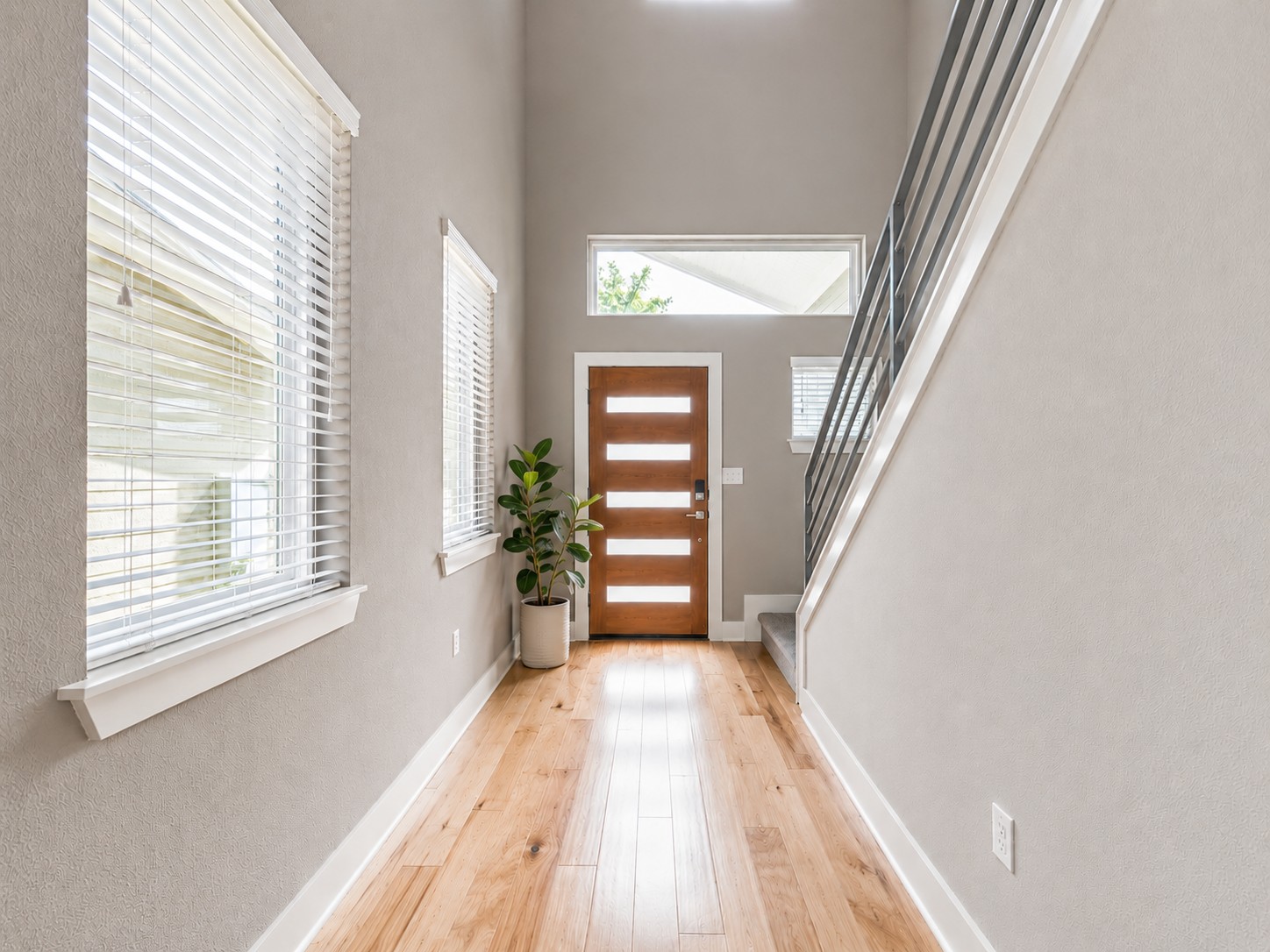 a view of a room with wooden floor and balcony