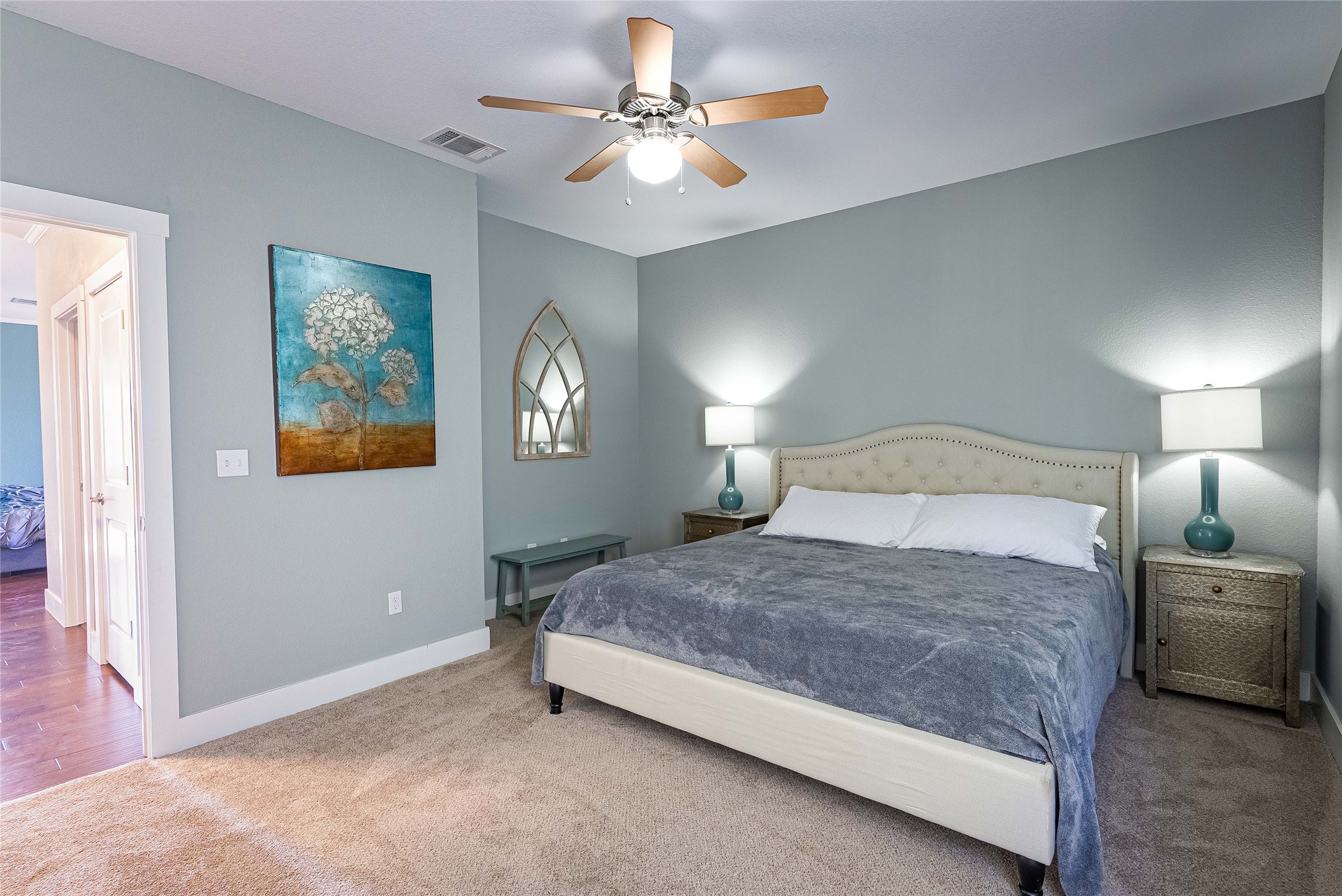 410 Summit Ridge Drive North Point Venture, TX 78645 - Photo 20 of 37 a spacious bedroom with a bed and a chandelier