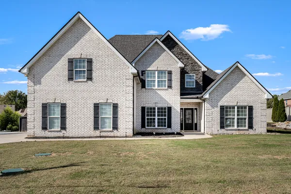 a front view of a house with a yard