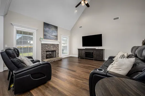 a kitchen with stainless steel appliances granite countertop a table chairs sink refrigerator and microwave