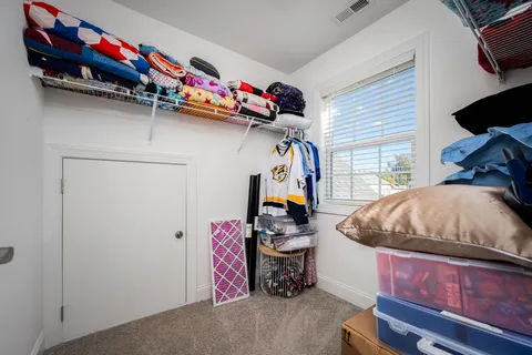 a bed room with a bed mirror and a window