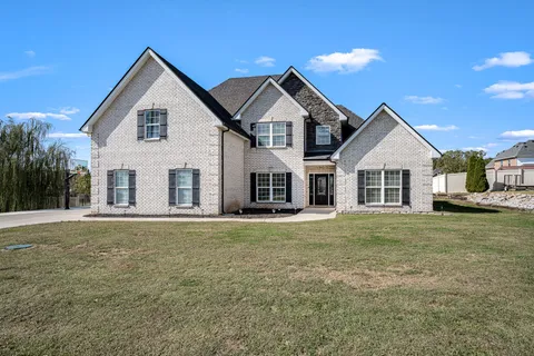 a view of a hallway with wooden floor and a living room