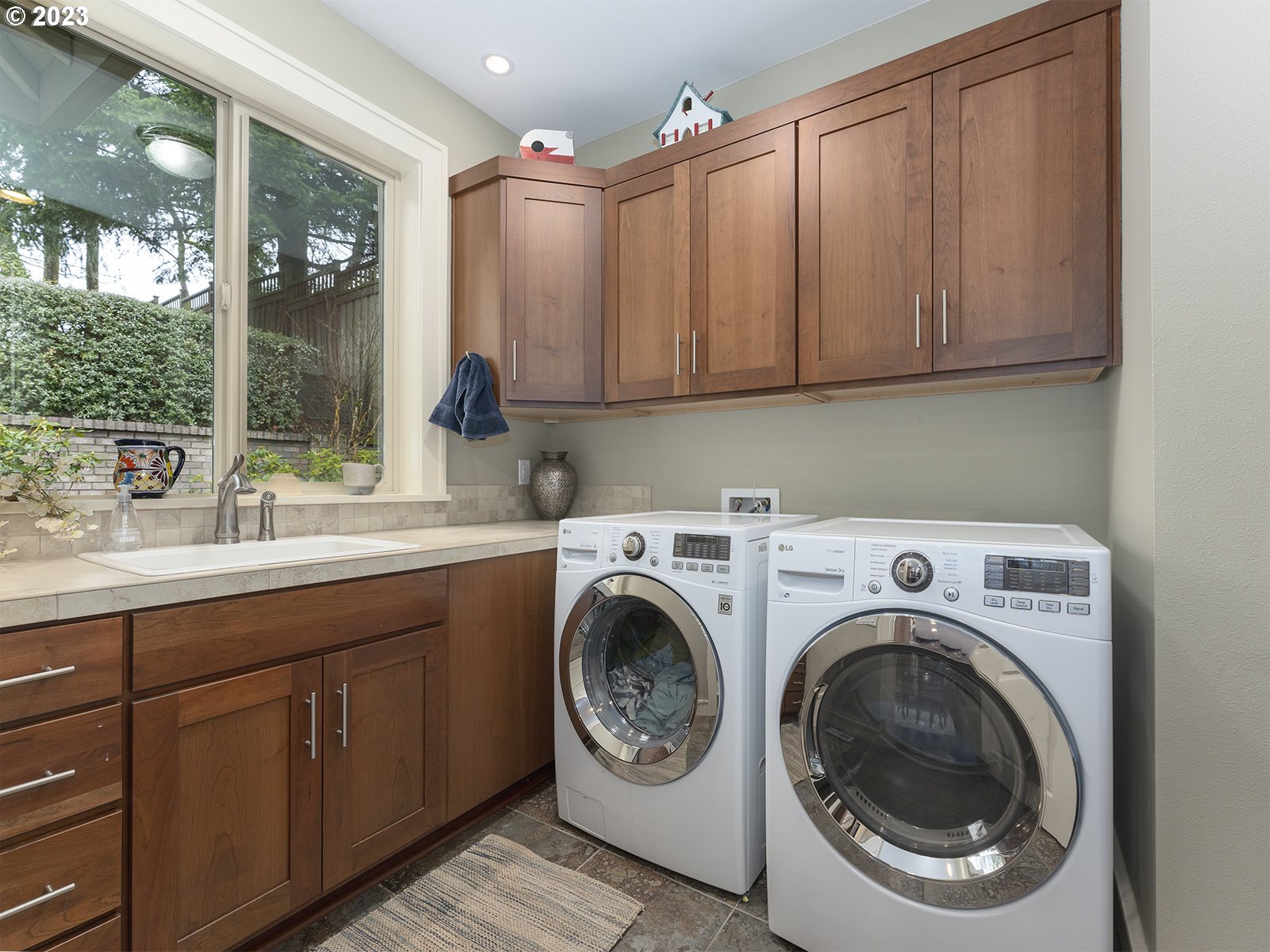1214 Southwest Ophelia Street Portland, OR 97219 - Photo 15 of 36 a view of a kitchen with washer and dryer
