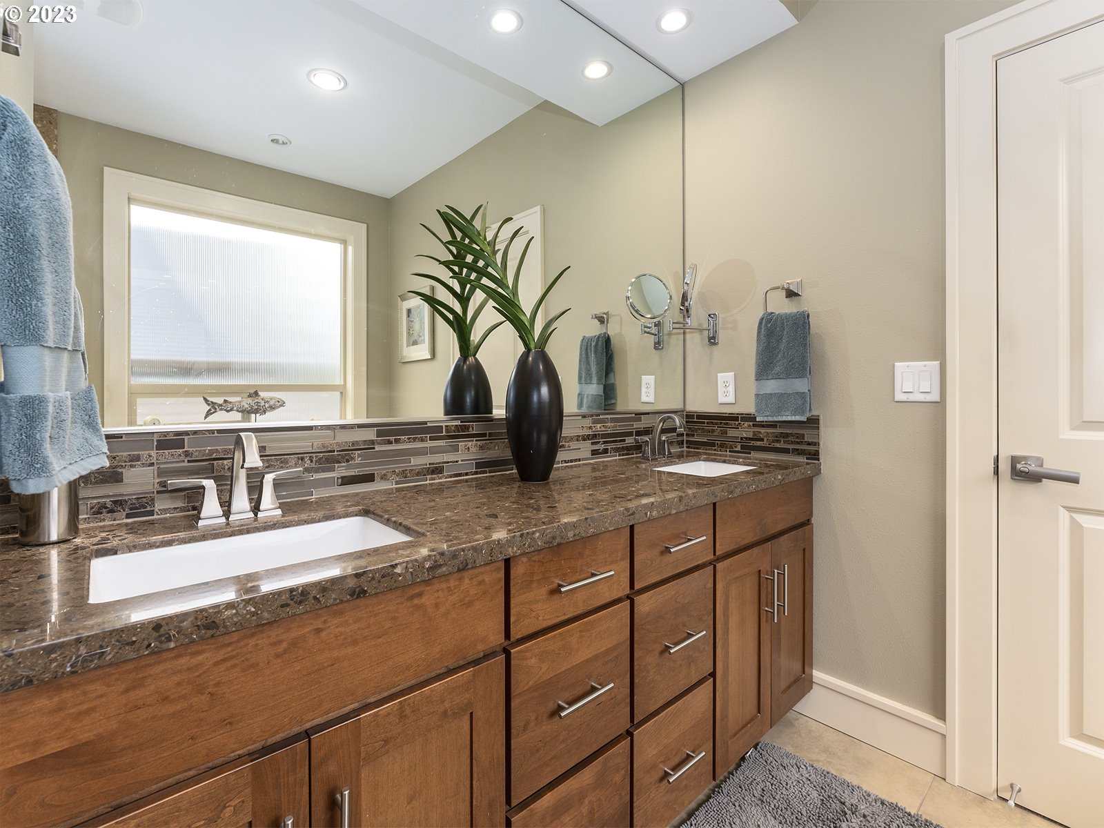 1214 Southwest Ophelia Street Portland, OR 97219 - Photo 22 of 36 a bathroom with a double vanity sink and a mirror