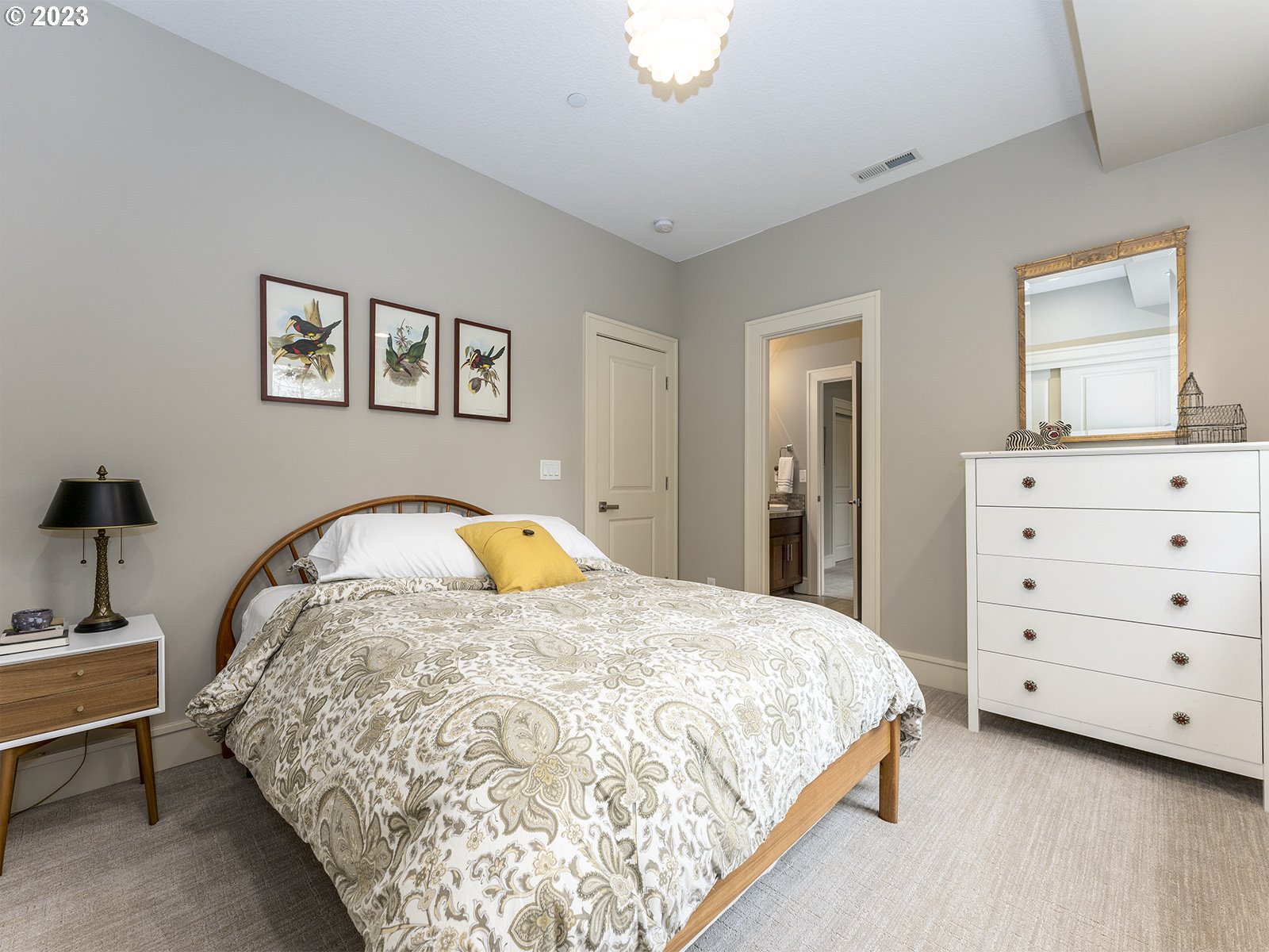 1214 Southwest Ophelia Street Portland, OR 97219 - Photo 24 of 36 a bed sitting in a bedroom and dresser
