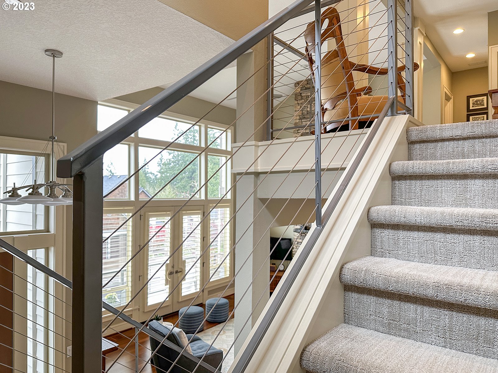 1214 Southwest Ophelia Street Portland, OR 97219 - Photo 29 of 36 a living room with furniture and a floor to ceiling window