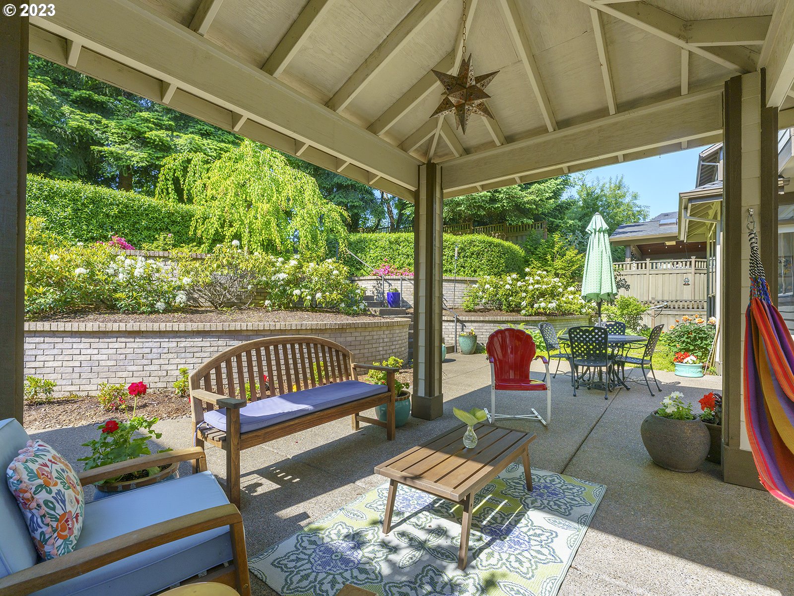 1214 Southwest Ophelia Street Portland, OR 97219 - Photo 34 of 36 a garden view with a seating space