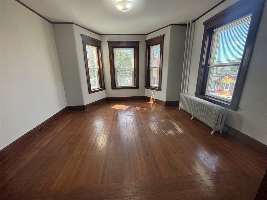 1 Harbor Street, Unit 1 Salem, MA 01970 - Photo 5 of 7 an empty room with wooden floor and windows