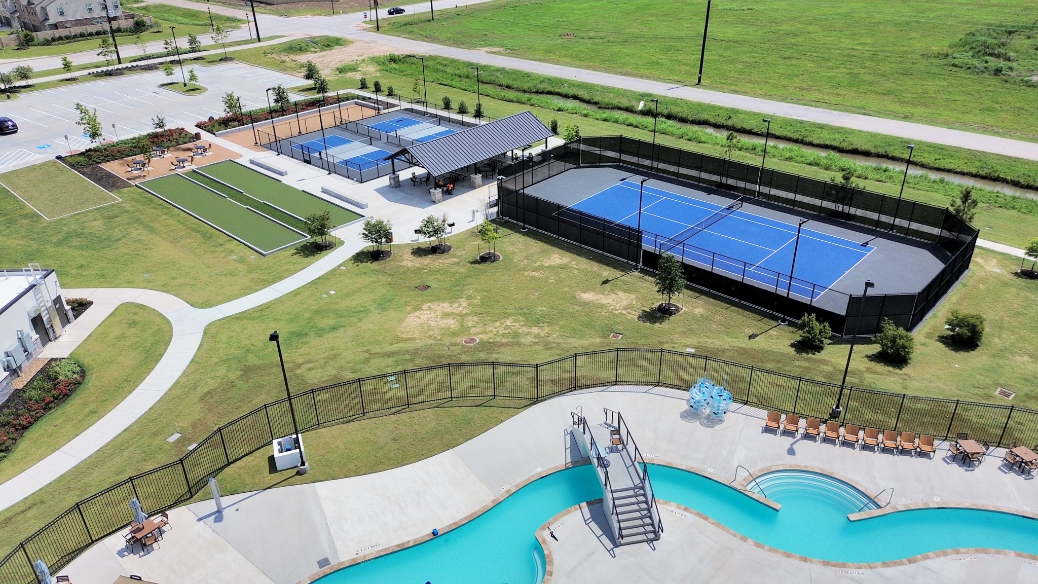 10314 Tuscan Valley Drive, Unit A Rosharon, TX 77583 - Photo 41 of 50 For relaxation and recreation residents can enjoy the Resort Style Amenity Village offering:Heated Lazy River,Resort Style Pool,Splash Pad,Playground,Multiple Sports Courts-Basketball,Pickleball,Bocce Ball,Tennis,Sports Field,Sand Beach,Cabana & Hammock area, Clubhouse with Fitness Center,Lounge,Great Room & Outdoor Pavillon.