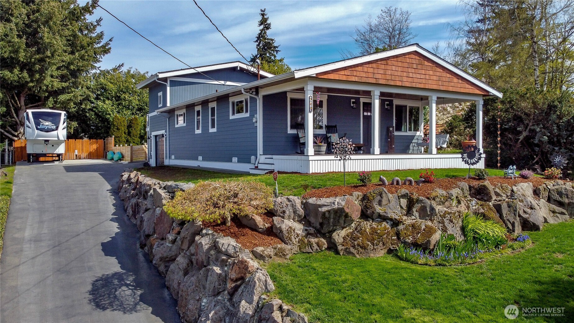 215 Southwest 183rd Street Normandy Park, WA 98166 - Photo 2 of 31 a front view of a house with garden