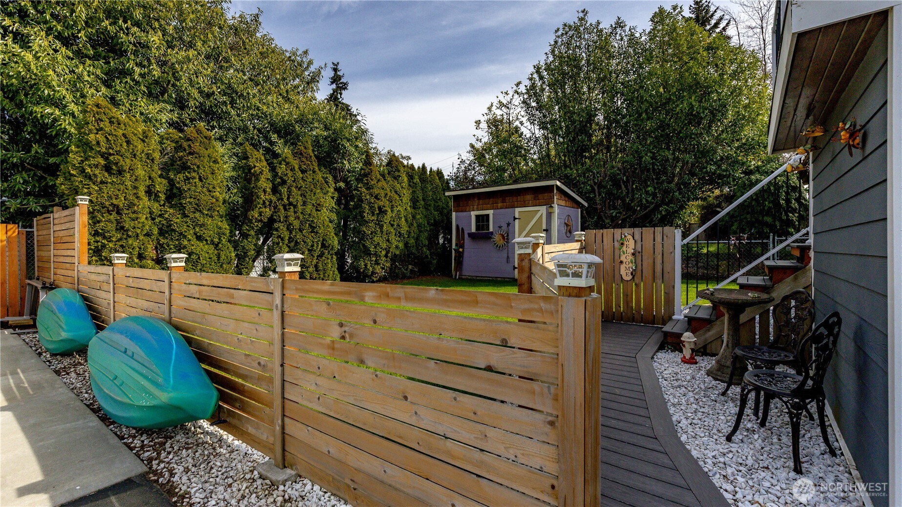 215 Southwest 183rd Street Normandy Park, WA 98166 - Photo 27 of 31 a view of house with backyard outdoor seating and trees