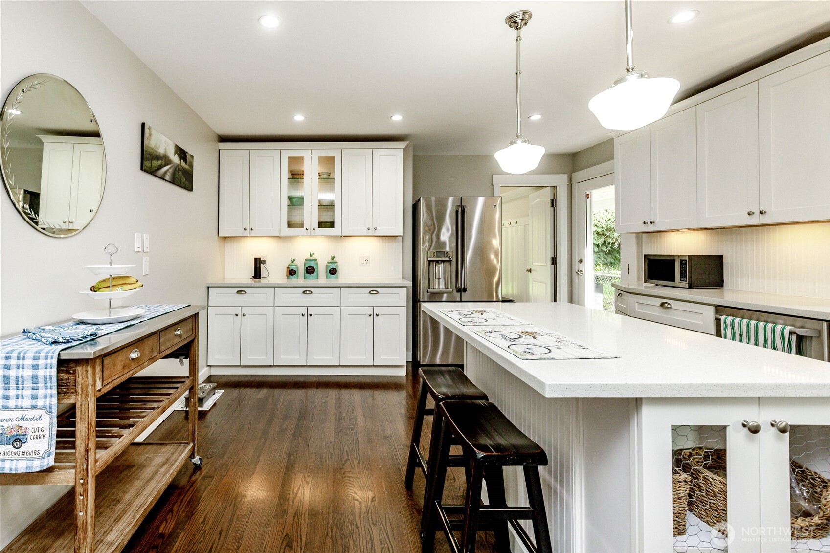 215 Southwest 183rd Street Normandy Park, WA 98166 - Photo 7 of 31 a kitchen with stainless steel appliances granite countertop a stove a refrigerator a oven a sink with a dining table and chairs
