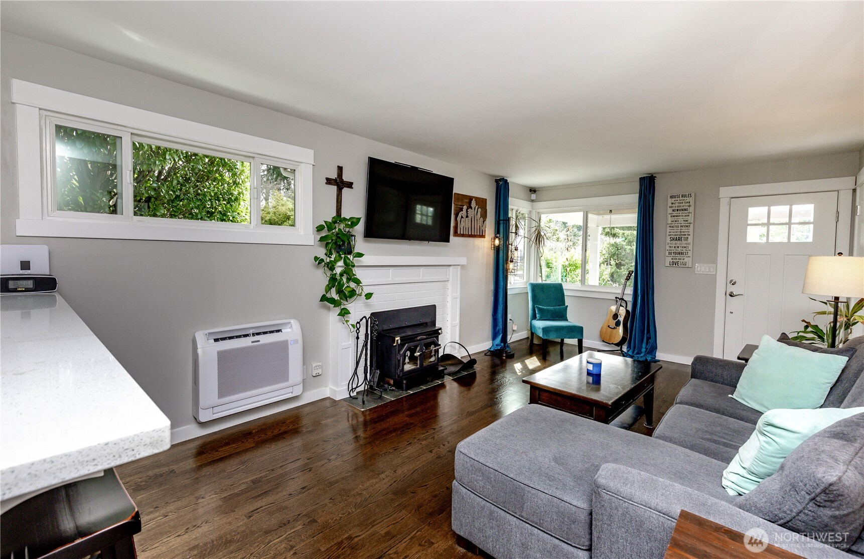 215 Southwest 183rd Street Normandy Park, WA 98166 - Photo 10 of 31 a living room with furniture a fireplace and a flat screen tv