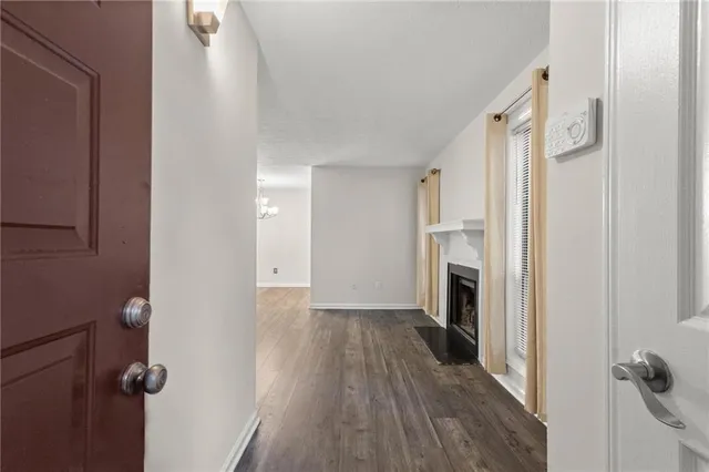 a view of a livingroom with wooden floor and a fireplace