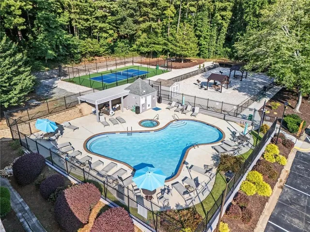 an aerial view of a house with outdoor seating