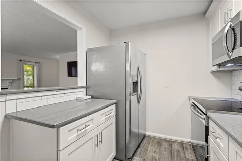 a kitchen with a stove and a refrigerator