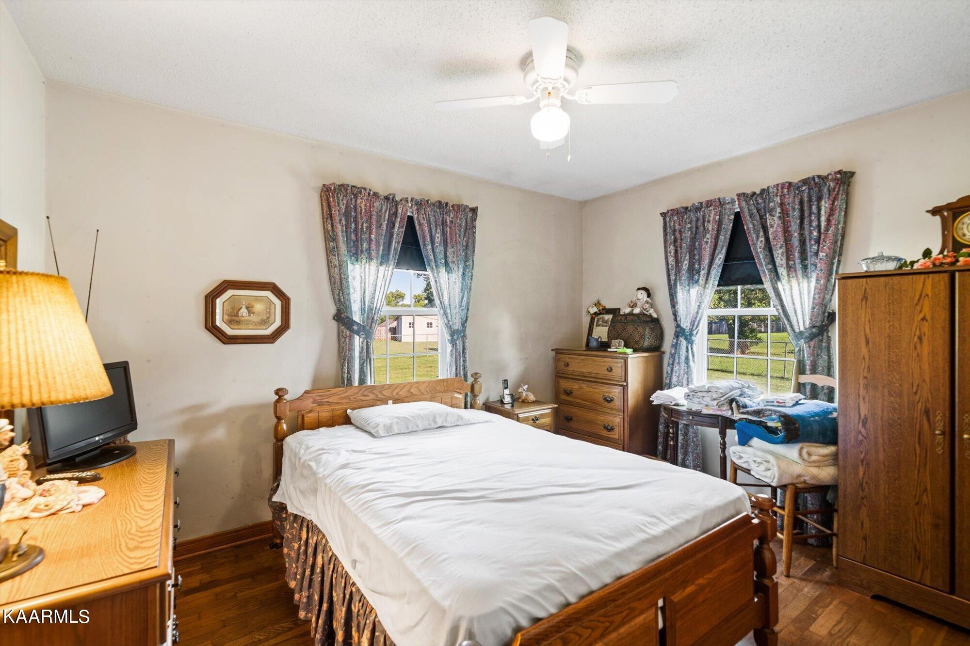1211 Spring Street Philadelphia, TN 37846 - Photo 9 of 25 a bedroom with a bed and a chandelier