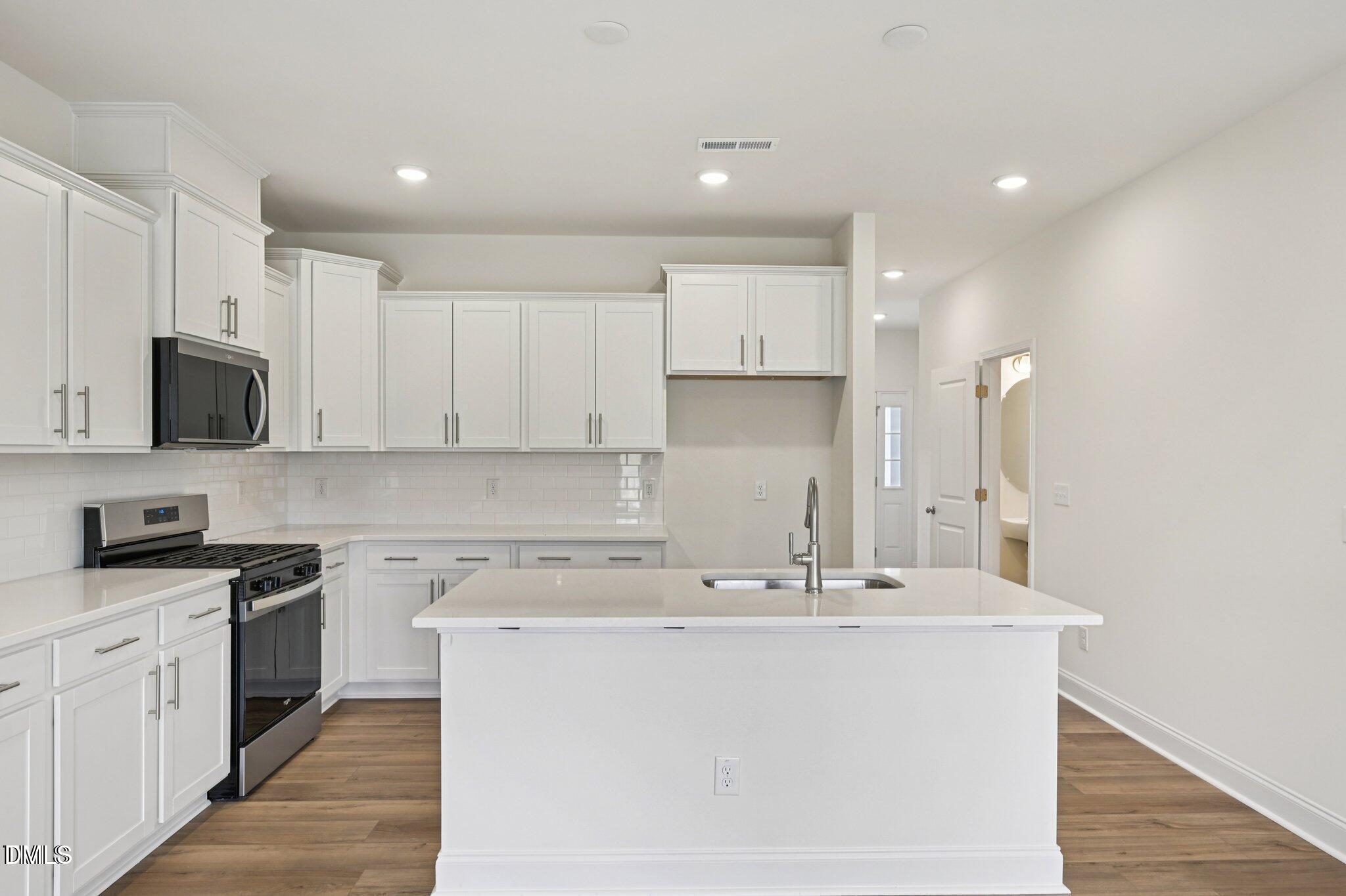 804 Kensley Grv Lane Fuquay-Varina, NC 27526 - Photo 11 of 28 a kitchen with stainless steel appliances a sink stove and microwave