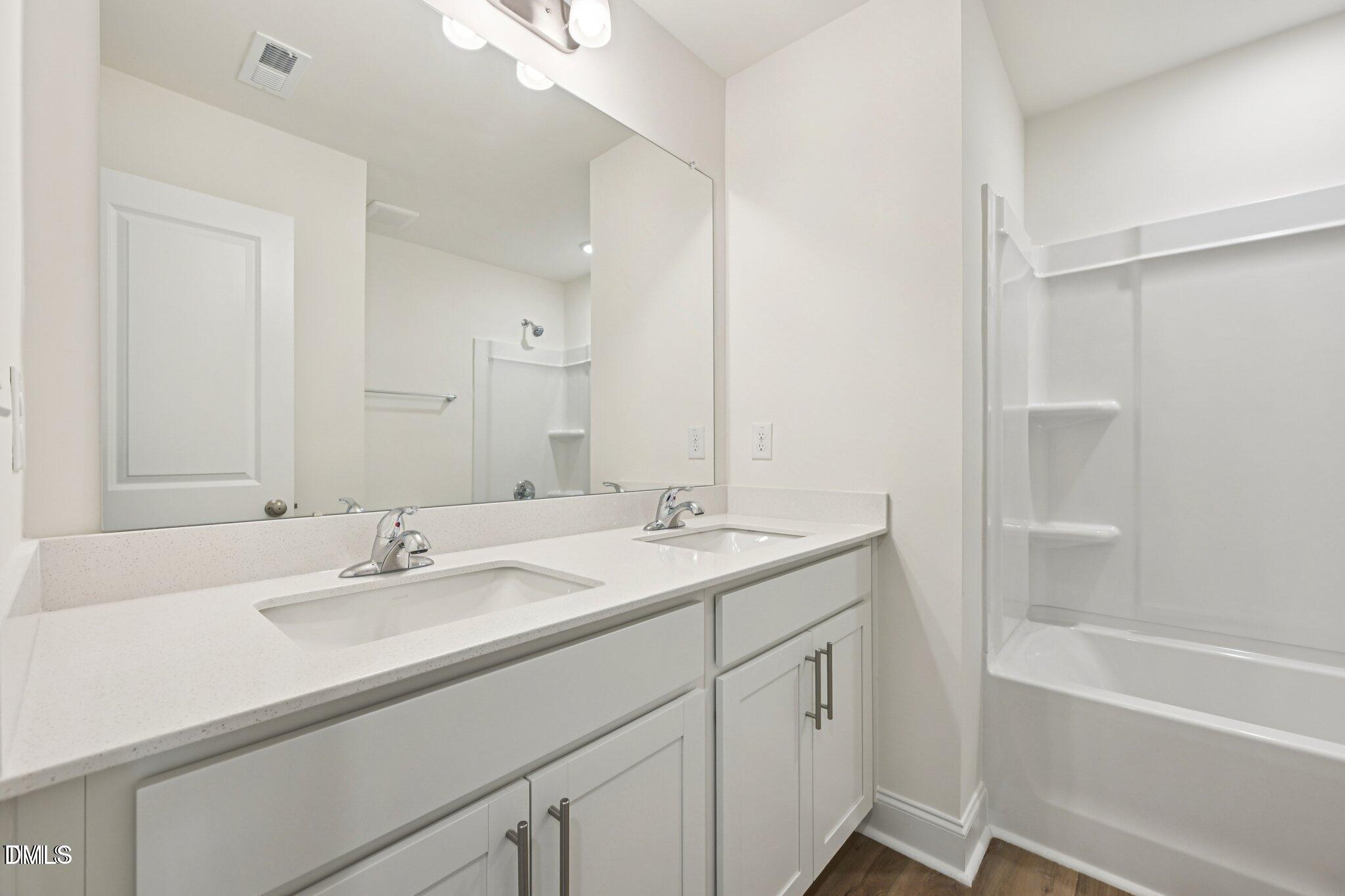 804 Kensley Grv Lane Fuquay-Varina, NC 27526 - Photo 15 of 28 a bathroom with a sink and a mirror