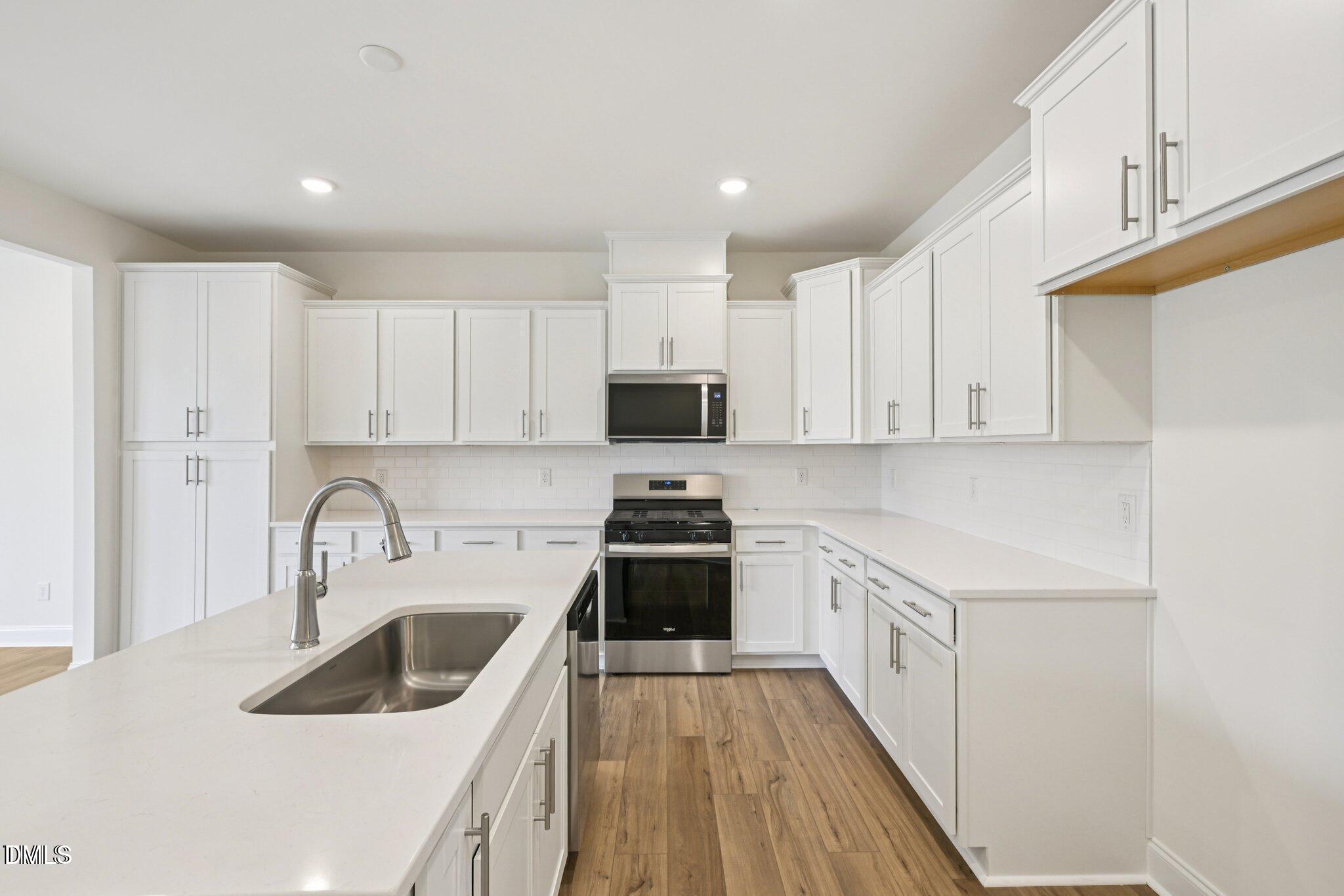 804 Kensley Grv Lane Fuquay-Varina, NC 27526 - Photo 2 of 28 a kitchen with a sink a stove and cabinets