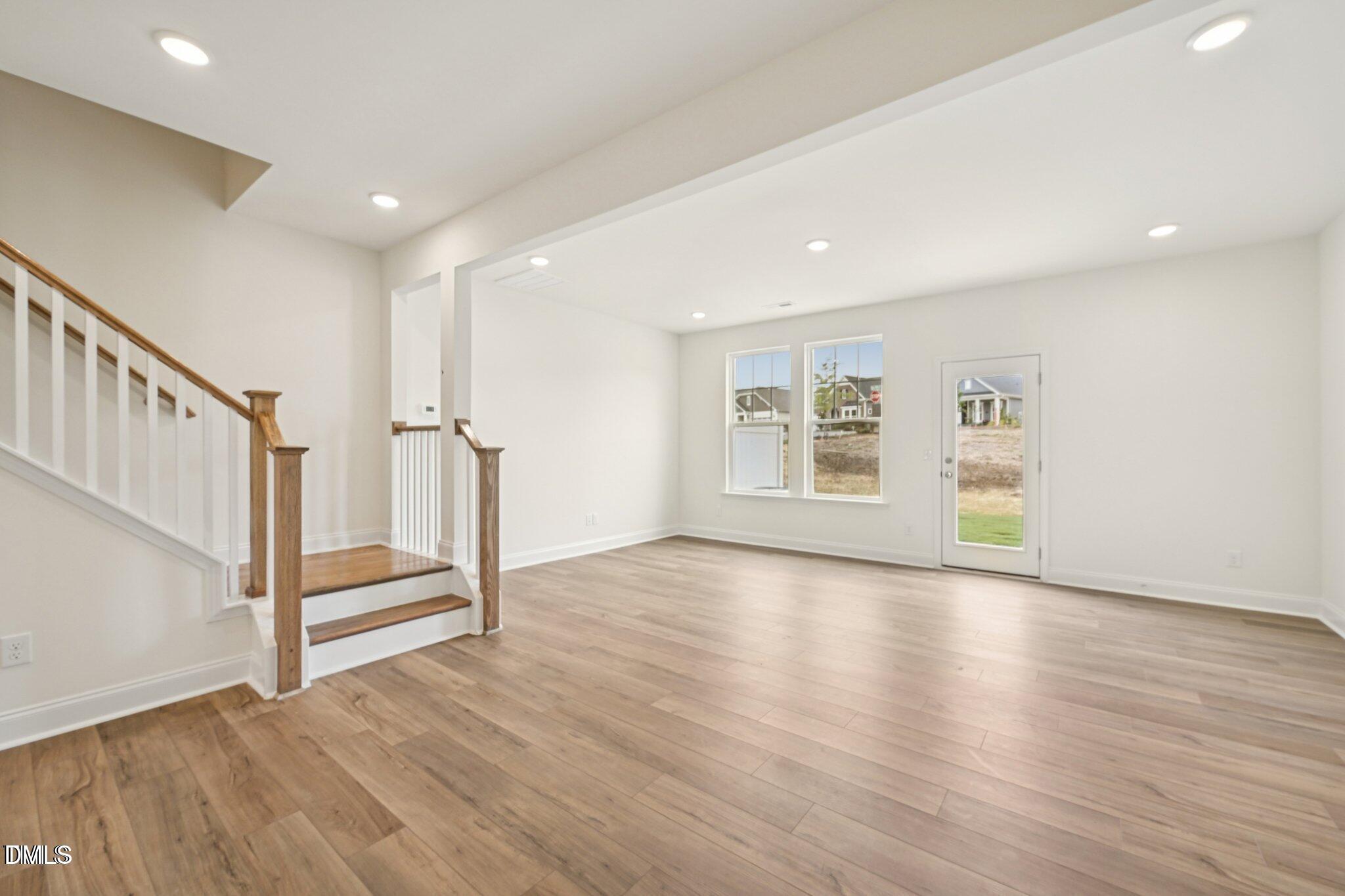 804 Kensley Grv Lane Fuquay-Varina, NC 27526 - Photo 4 of 28 a view of an empty room with wooden floor and stairs