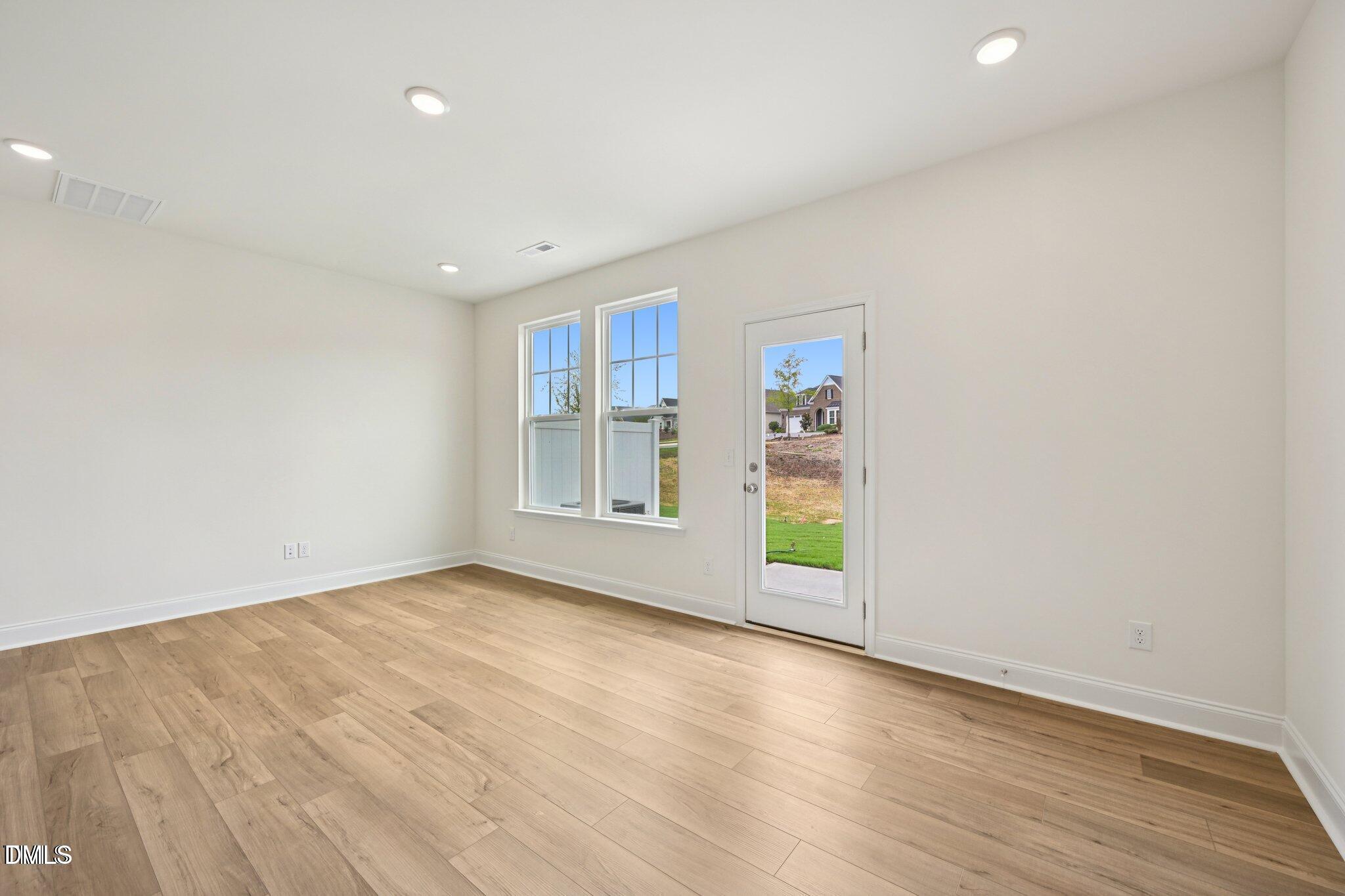 804 Kensley Grv Lane Fuquay-Varina, NC 27526 - Photo 5 of 28 an empty room with wooden floor and windows
