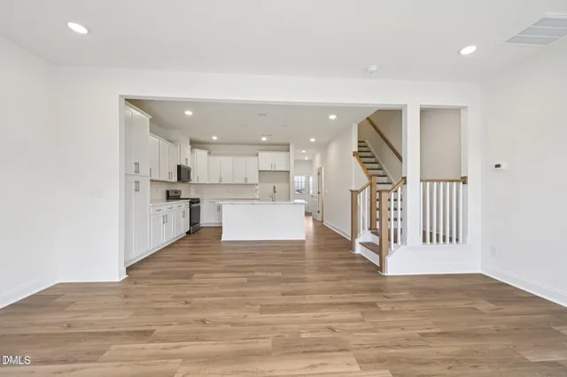 a kitchen with a sink stainless steel appliances and white cabinets