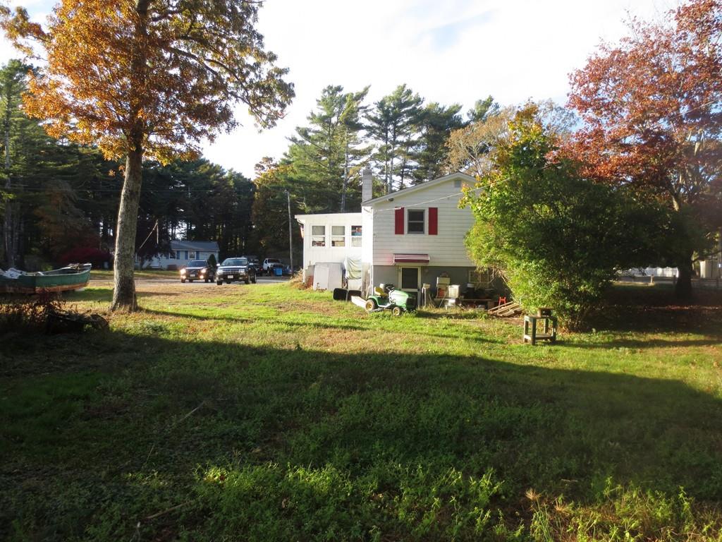 137 Great Neck Road Wareham, MA 02571 - Photo 3 of 8 a view of a house with backyard and trees