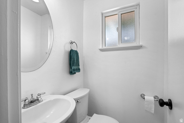 480 North 150 E Street Springville, UT 84663 - Photo 15 of 36 Powder room featuring a circular mirror, pedestal sink with chrome fixtures, and a frosted window