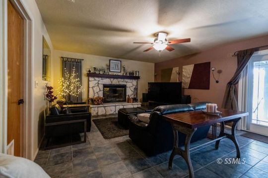 908 North Inyo Street Ridgecrest, CA 93555 - Photo 16 of 46 a living room with furniture a fireplace and a flat screen tv