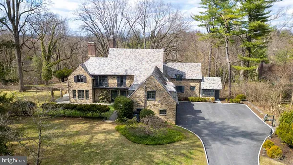 a view of a house with a yard covered with snow