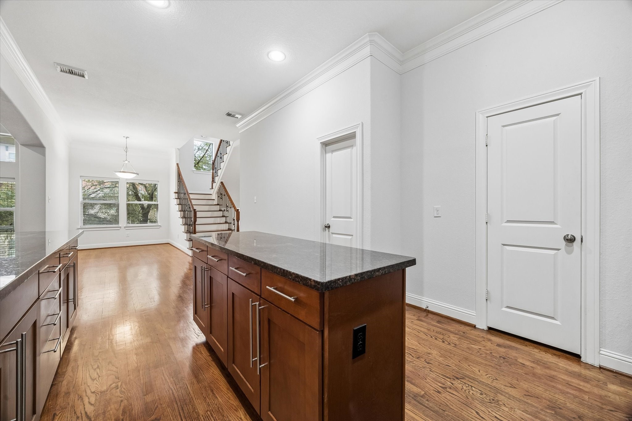 1033 West 23rd Street Houston, TX 77008 - Photo 12 of 25 a hallway with wooden cabinets and staircase