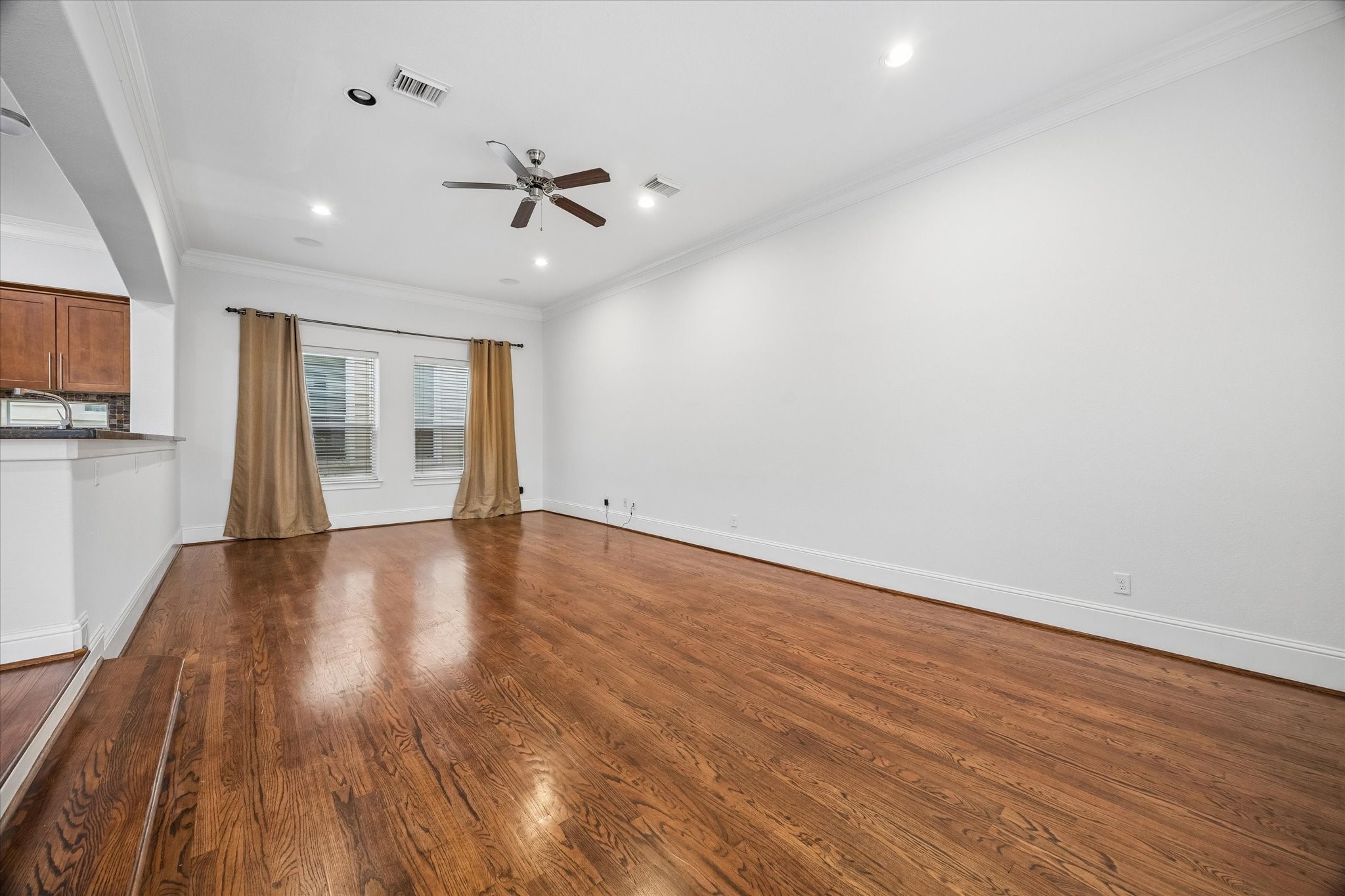 1033 West 23rd Street Houston, TX 77008 - Photo 13 of 25 a view of an empty room with wooden floor and a window