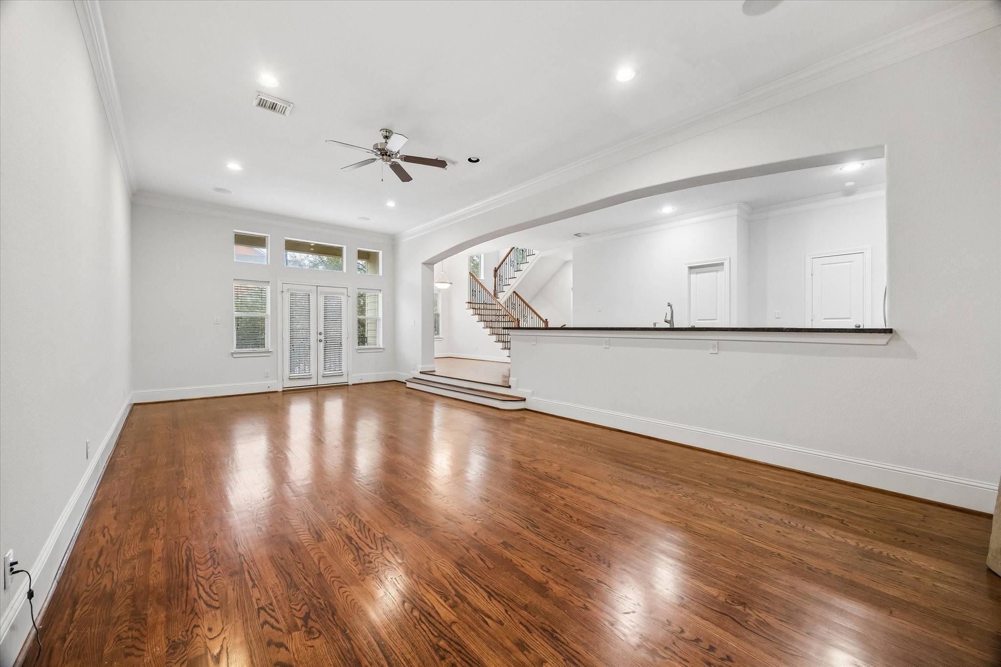 1033 West 23rd Street Houston, TX 77008 - Photo 14 of 25 a view of an empty room with wooden floor and a window