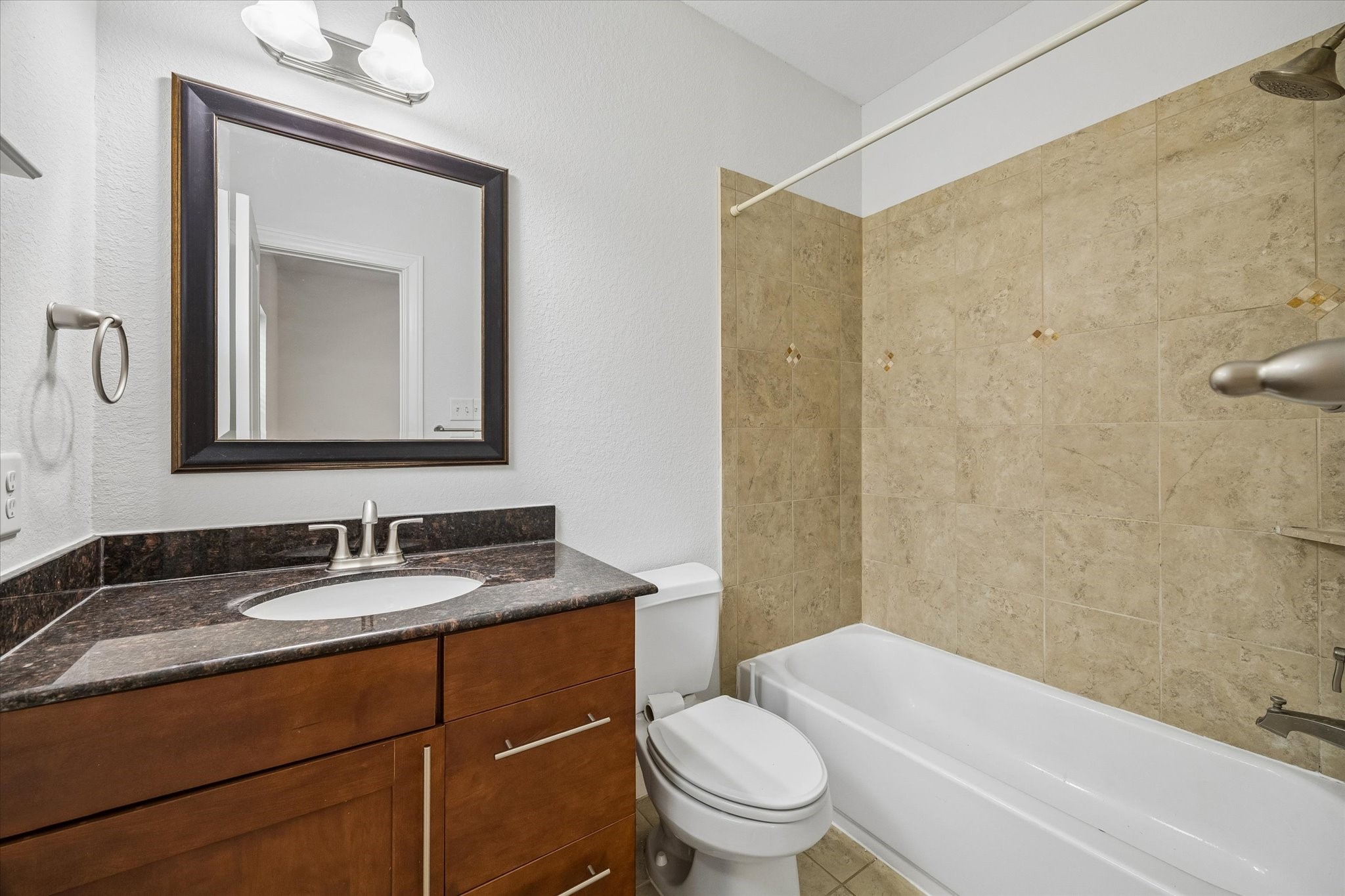 1033 West 23rd Street Houston, TX 77008 - Photo 23 of 25 a bathroom with a granite countertop sink toilet and shower