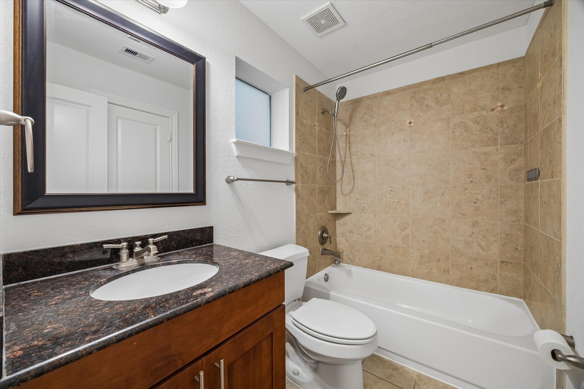 1033 West 23rd Street Houston, TX 77008 - Photo 7 of 25 a bathroom with a granite countertop sink toilet mirror and shower