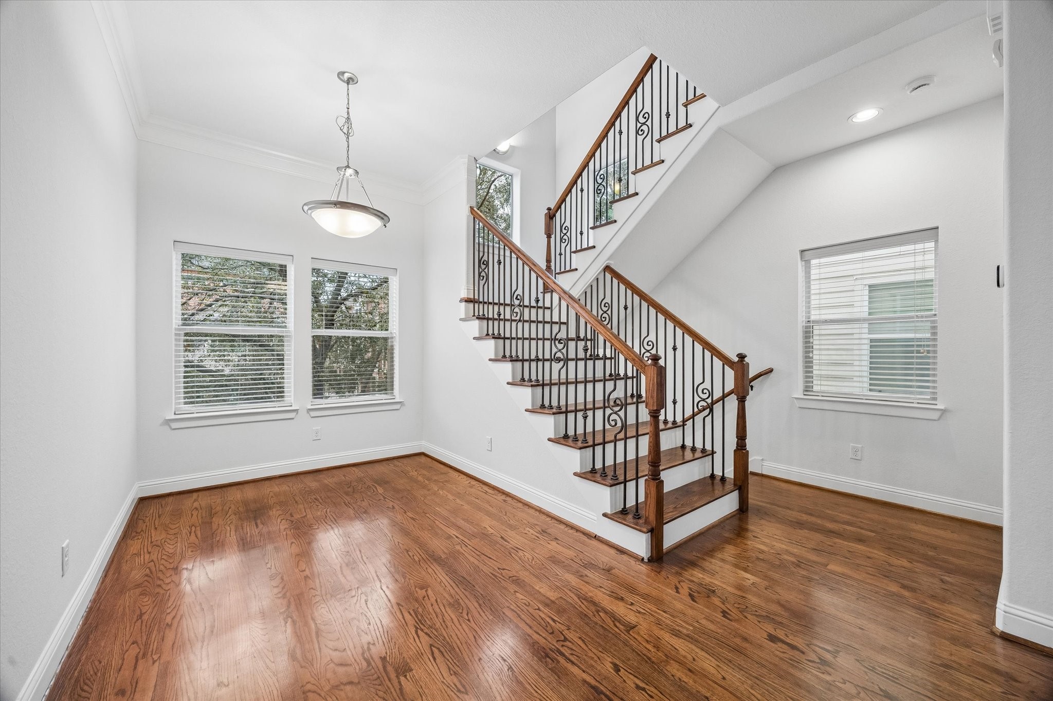 1033 West 23rd Street Houston, TX 77008 - Photo 9 of 25 a view of staircase with wooden floor and window
