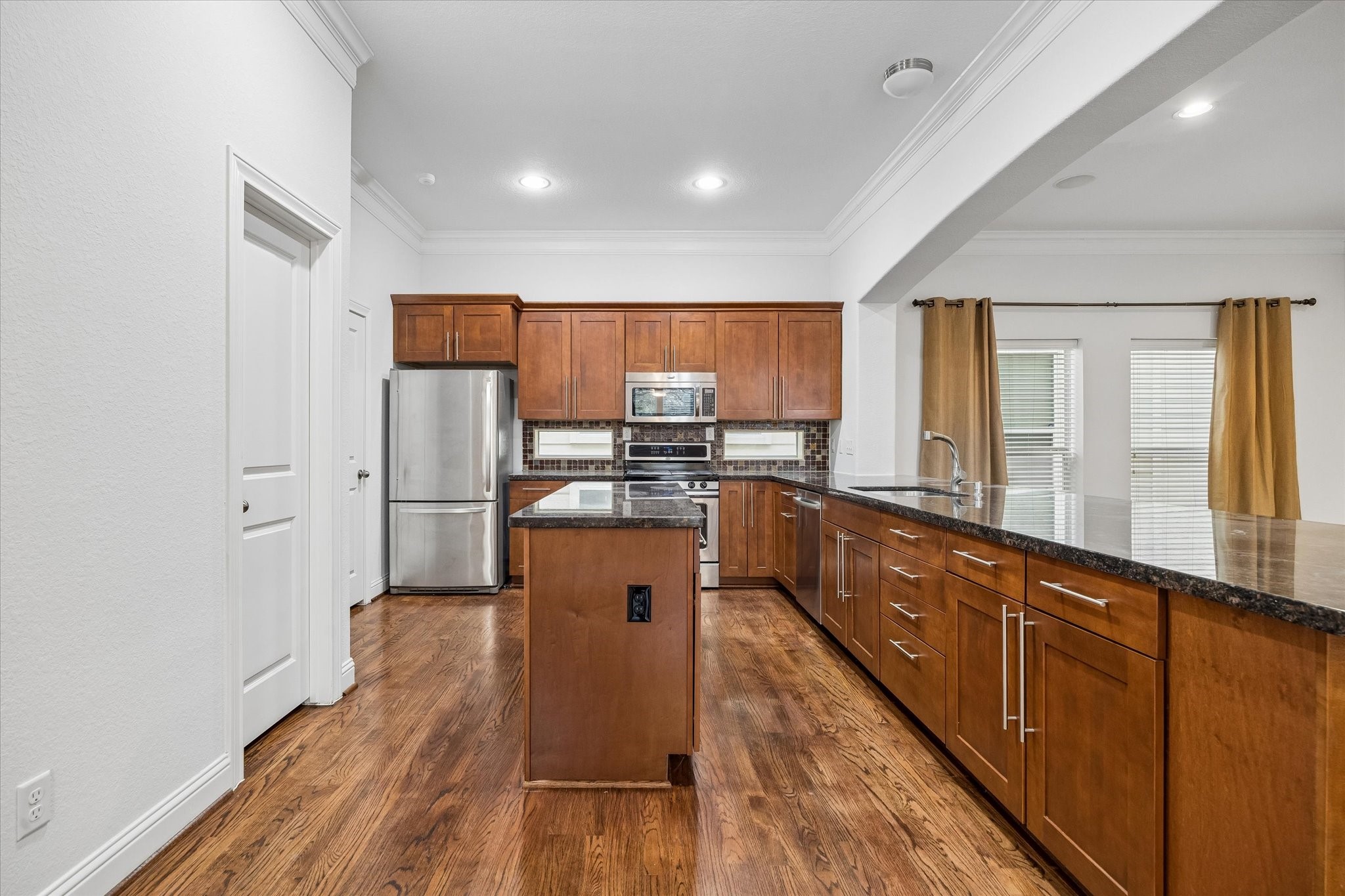 1033 West 23rd Street Houston, TX 77008 - Photo 10 of 25 a kitchen with stainless steel appliances granite countertop a refrigerator sink and wooden cabinets