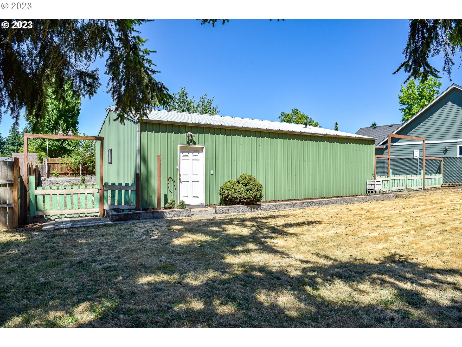 738 West N Street, Unit 2 Springfield, OR 97477 - Photo 6 of 9 a view of a house with a backyard and a tree