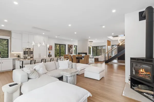 a living room with furniture and a chandelier
