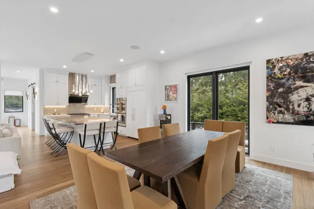 a view of a roof deck with wooden floor and outdoor seating
