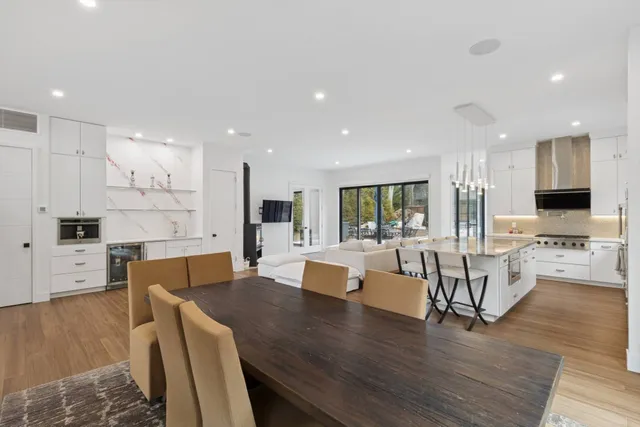 a bathroom with a toilet a sink a mirror and a window